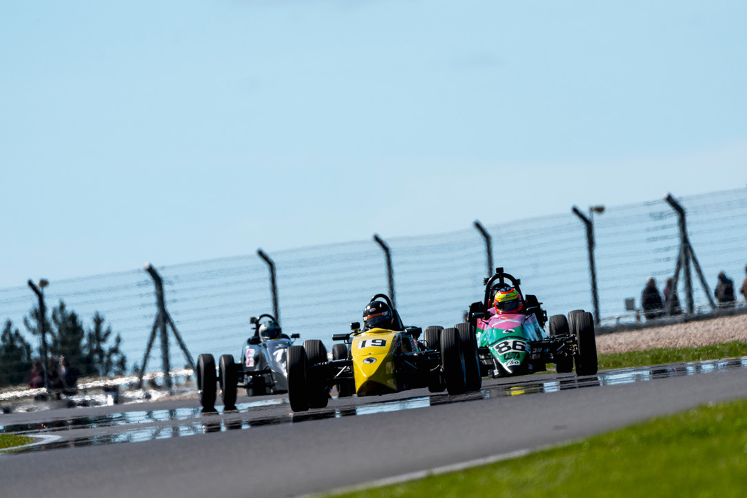 Three cars on a damp track