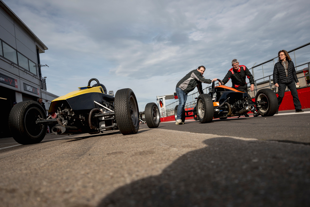 Cars pushed down the pit lane